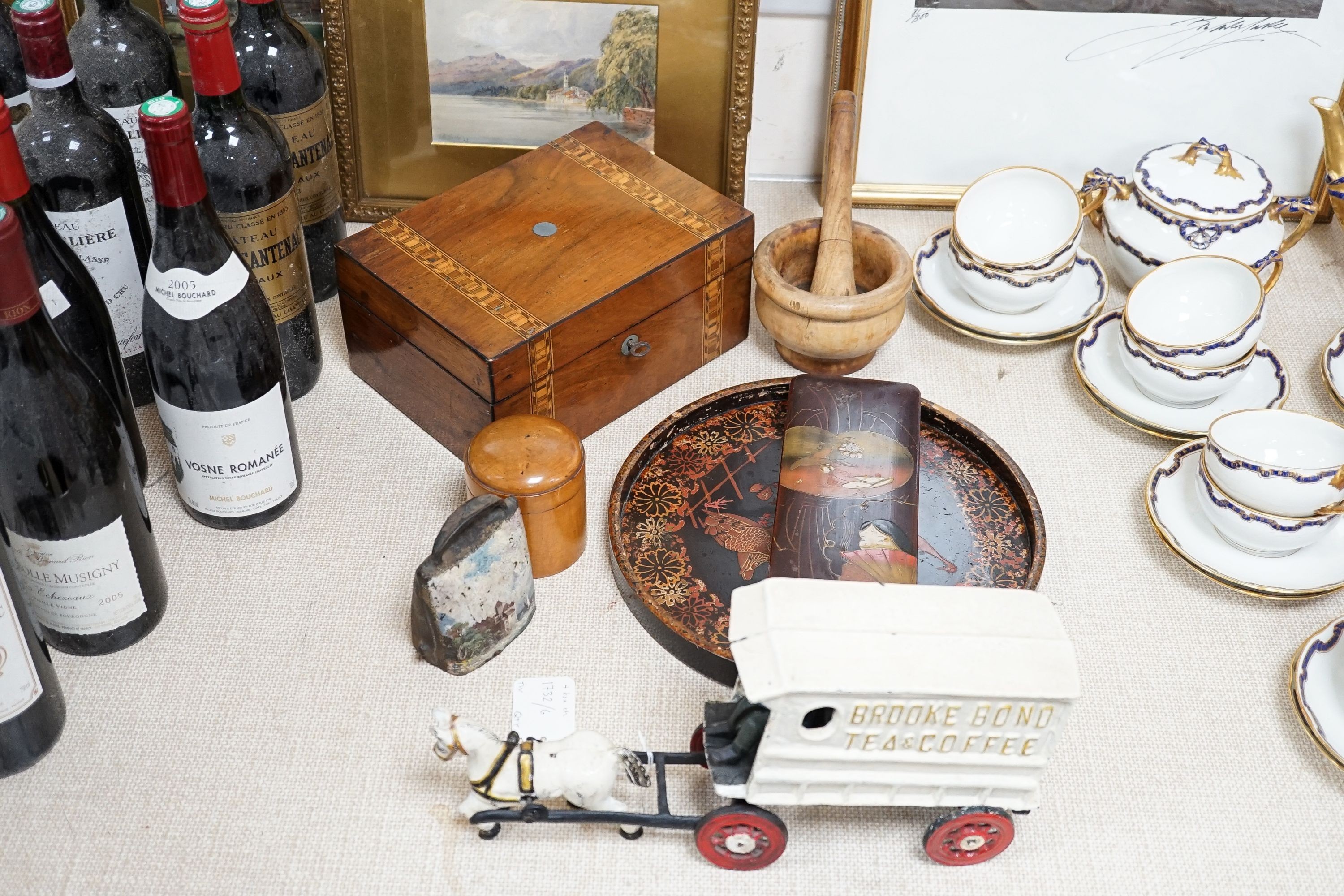 A miscellaneous collection comprising a painted cast iron Brooke Bond pony and cart, train items to include a mortar and pestle, a European painted cowbell, lacquer wares et cetera